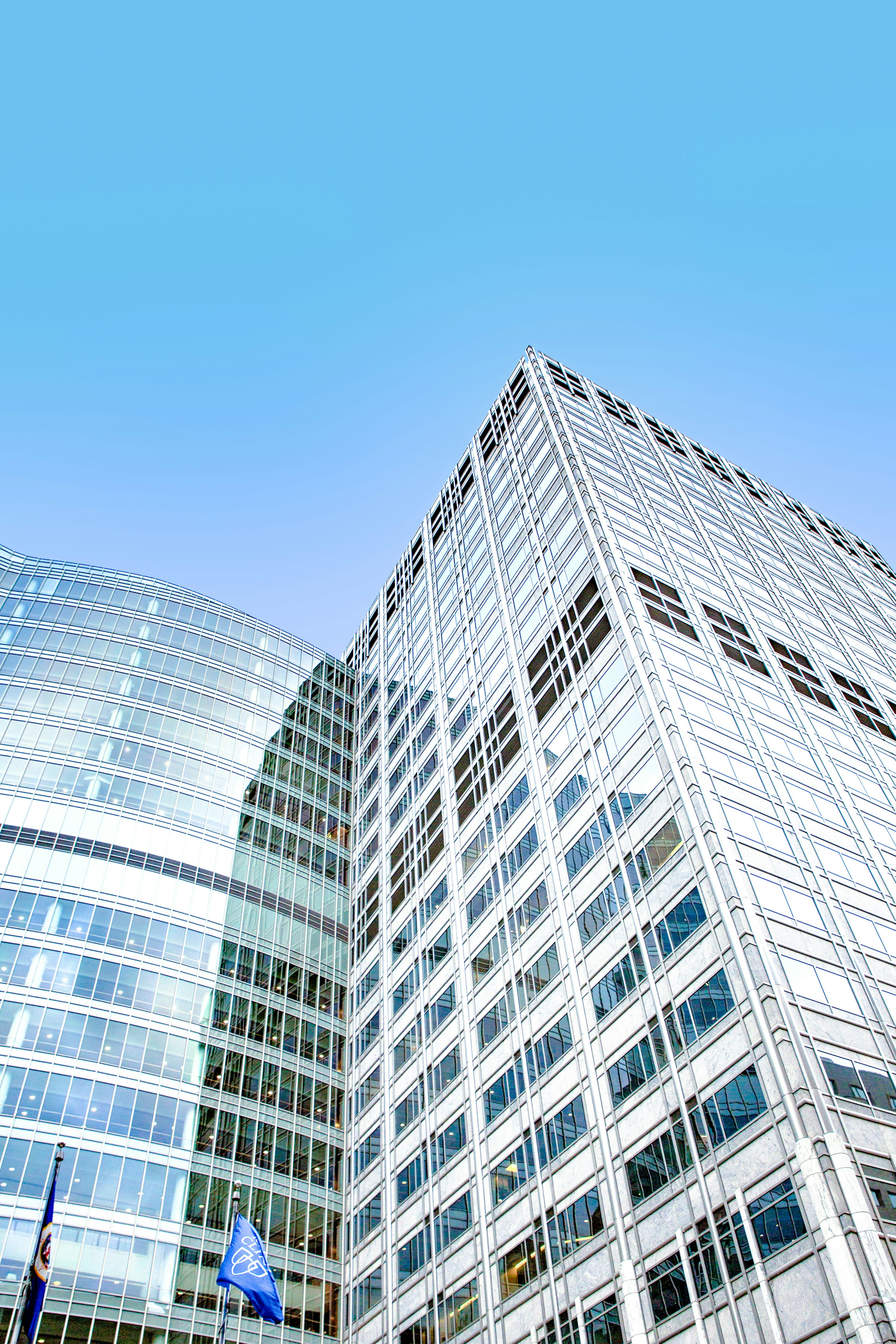 Modern glass office buildings beneath a clear blue sky