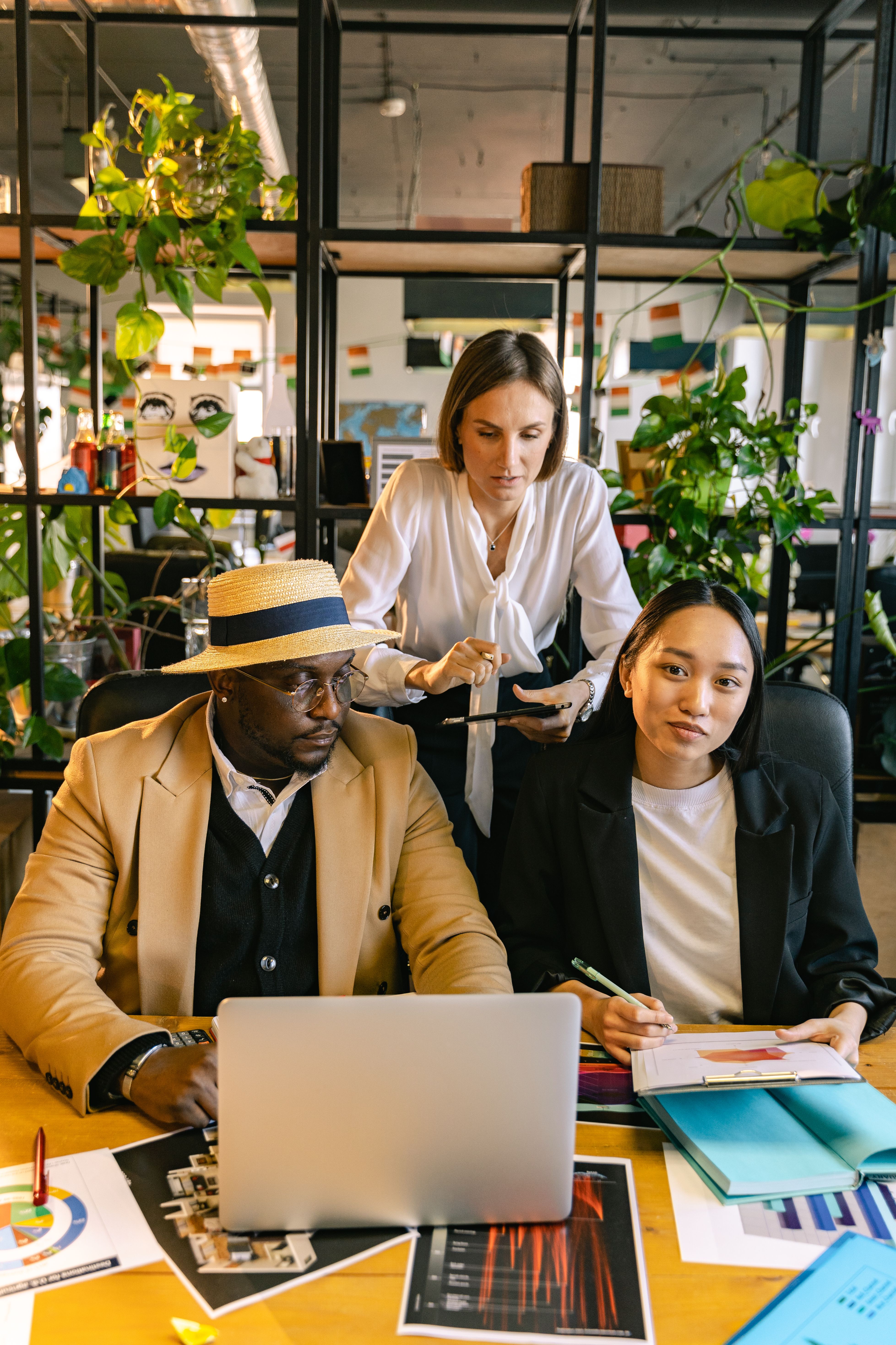 Professionals collaborating over market analysis at an office table